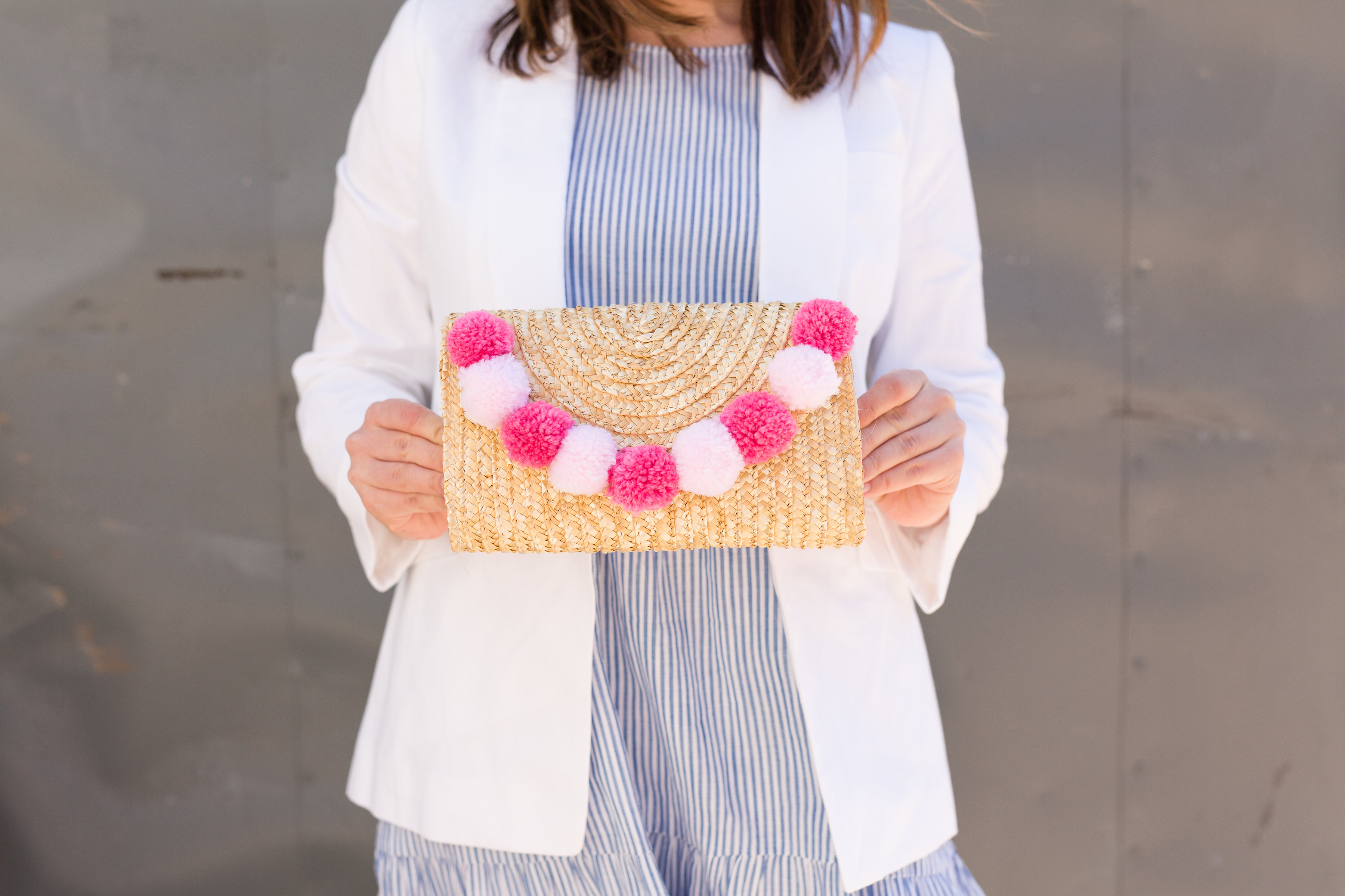 Straw clutch bag on sale with pom poms